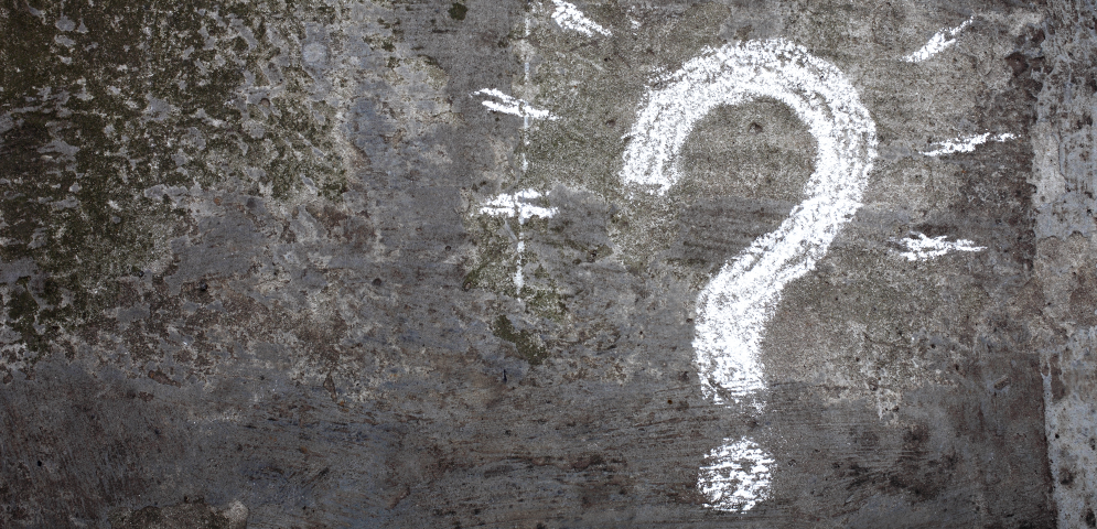 Question mark on gray wall