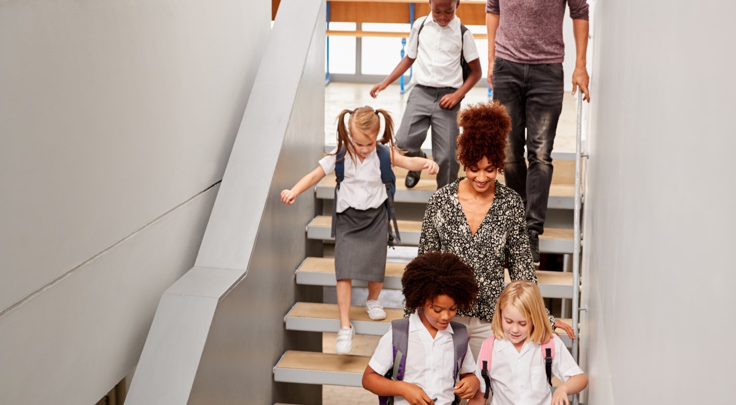 Young Students Walking Down Stairwell